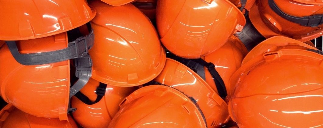 Orange hard hats to protect tradespeople on building sites