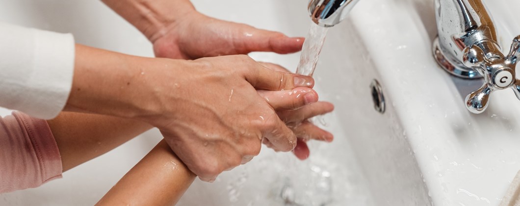Employees washing their hands to protect the business