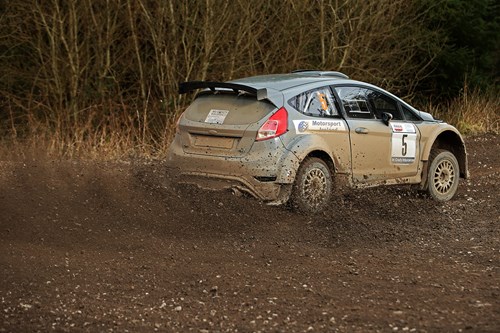 grey ford focus rally car skids in the mud at mcgrady insurance ni rally